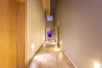 an empty hallway with a purple light in the distance at Haut-Standing, Marrakech Guéliz, Piscine in Marrakech