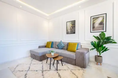 a living room with a couch and a table at NEW! Cosy, Lux , Gueliz centre, Iptv in Marrakech