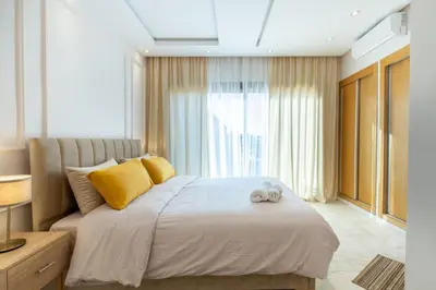a bedroom with a bed with a stuffed animal on it at NEW! Cosy, Lux , Gueliz centre, Iptv in Marrakech