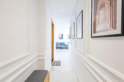 a hallway with white walls and pictures on the walls at NEW! Cosy, Lux , Gueliz centre, Iptv in Marrakech