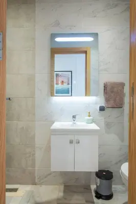 a bathroom with a white sink and a mirror at NEW! Cosy, Lux , Gueliz centre, Iptv in Marrakech