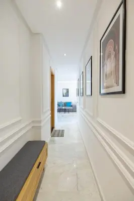 a hallway of a house with white walls and a bench at NEW! Cosy, Lux , Gueliz centre, Iptv in Marrakech