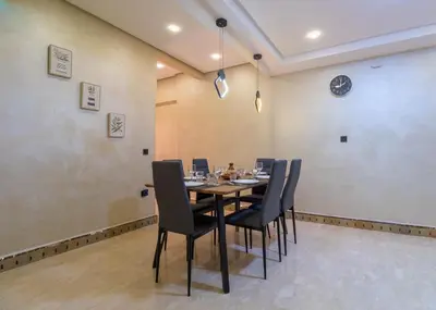 a dining room with a table and chairs at Harmony Inn Entire 2 bedroom apartment in Marrakech