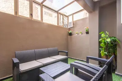 a patio with a bench and two chairs at Relax, Modern, Centre Gueliz in Marrakech