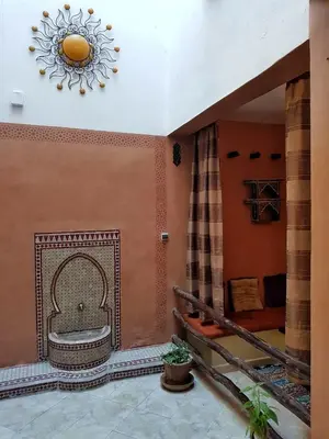 a room with a tub in the wall with a clock at Maison style riad aux chants des oiseaux in Marrakech