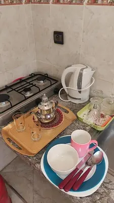 a counter top with plates and cups and a stove at Maison style riad aux chants des oiseaux in Marrakech
