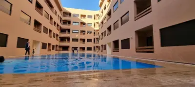 a swimming pool in the middle of a building at Bonheur Partagé 1 in Marrakech