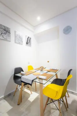 a dining room with a wooden table and yellow chairs at NEW! Luxury’n Colorful, Gueliz in Marrakech