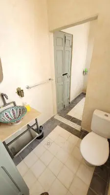 a bathroom with a toilet and a sink at Riad Nohad Marrakech Villa Privatisée in Oulad Boudene