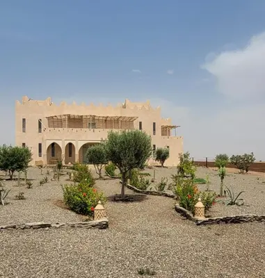 a large building in the middle of a desert at Riad Nohad Marrakech Villa Privatisée in Oulad Boudene