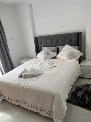 a bedroom with a bed with white sheets and pillows at PALACE B Av Hassan II Marrakech 40000 -Brand New Luxury UNIT#2 & UNIT#29 in Marrakech