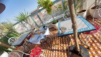 a table and chairs on a balcony with plants at Dar 