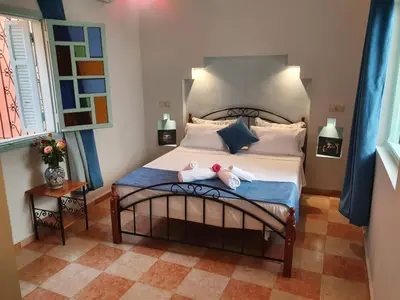 a bedroom with a bed with two dolls on it at Dar 