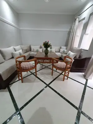 a living room with a couch and a table and chairs at Dar 