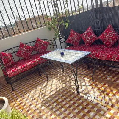 a patio with couches and a table on a balcony at Dar 