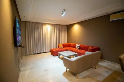a living room with a couch and a tv at studio design carre eden gueliz IPTV , NETFLIX , WIFI, in Marrakech