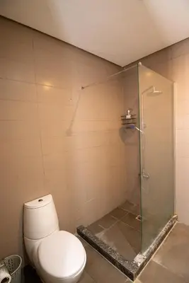 a bathroom with a toilet and a glass shower at studio design carre eden gueliz IPTV , NETFLIX , WIFI, in Marrakech