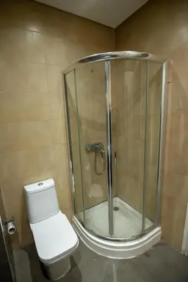 a bathroom with a glass shower with a toilet at studio design carre eden gueliz IPTV , NETFLIX , WIFI, in Marrakech