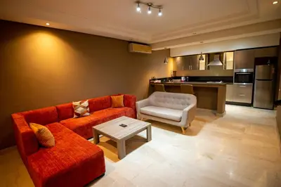 a living room with a couch and a table at studio design carre eden gueliz IPTV , NETFLIX , WIFI, in Marrakech