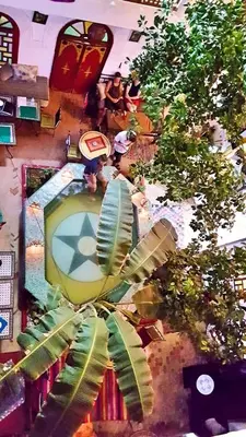 an overhead view of a room with a clock and trees at Riad Dia in Marrakech