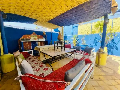 a living room with a couch and a table at Riad Dia in Marrakech