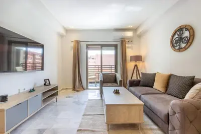 a living room with a couch and a tv at NEW! Élégance, Gueliz, Terrase, IPTV in Marrakech