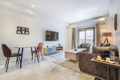 a living room with a couch and a table at NEW! Élégance, Gueliz, Terrase, IPTV in Marrakech