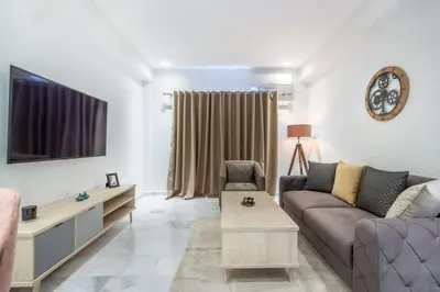 a living room with a couch and a tv at NEW! Élégance, Gueliz, Terrase, IPTV in Marrakech