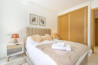 a bedroom with a large white bed with two pillows at NEW! Élégance, Gueliz, Terrase, IPTV in Marrakech