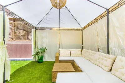 a living room with a couch in a tent at NEW!, Jardin privé, transats, barbecue in Marrakech