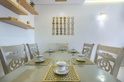 a dining room with a table and chairs with cups and saucers at NEW! Appartement de luxe emplacement idéal Gueliz in Marrakech
