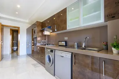 a kitchen with a washing machine and a sink at NEW! Appartement de luxe emplacement idéal Gueliz in Marrakech