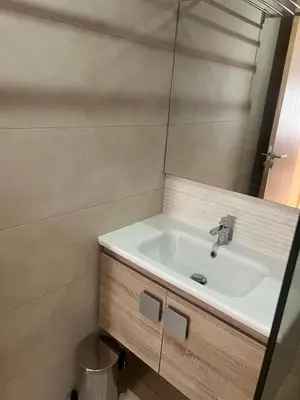 a bathroom with a sink and a mirror at APPARTEMENT CARRE EDEN in Marrakech
