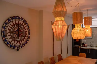 a dining room with chandeliers and a plate on the wall at Riad Dar Labzar in Marrakech
