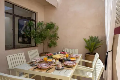a white table with plates of food on it at Riad Dar Labzar in Marrakech