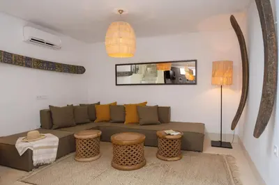 a living room with a couch and two tables at Riad Dar Labzar in Marrakech