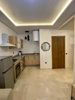 a kitchen with wooden cabinets and a door in it at Appartement 2 chambres salon centre de Gueliz 19 in Marrakech