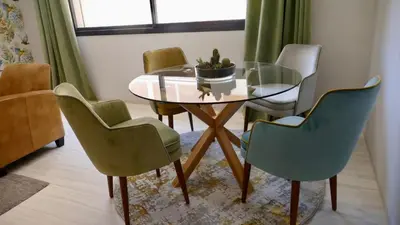 a dining room with a glass table and chairs at Appartement 2 chambres salon a cote centre de Gueliz 12 in Marrakech