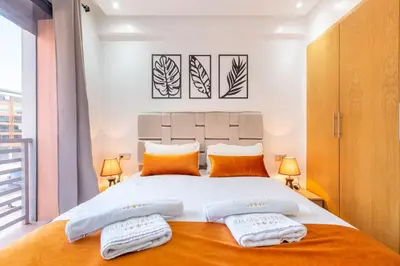 a bedroom with a large bed with two pillows at New! Appartemant au millieu de guéliz in Marrakech