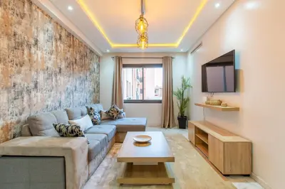 a living room with a couch and a tv at New! Appartemant au millieu de guéliz in Marrakech