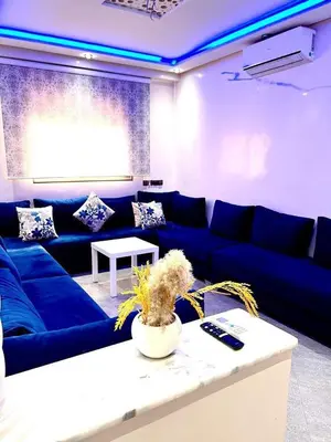 a living room with a blue couch and a table at La koutoubia in Marrakech