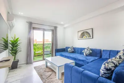 a living room with a blue couch and a table at NEW! Gueliz,Terrasse, Fibre optique, IPTV in Marrakech
