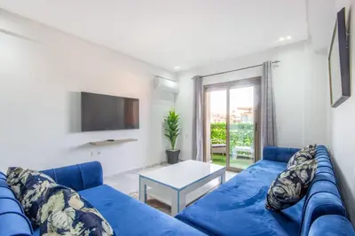 a blue couch in a living room with a table at NEW! Gueliz,Terrasse, Fibre optique, IPTV in Marrakech