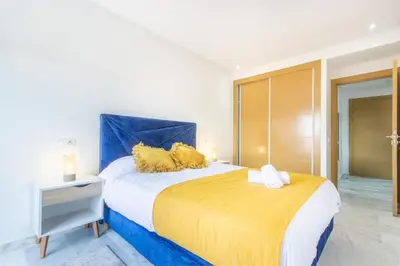 a bedroom with a large bed with yellow and blue at NEW! Gueliz,Terrasse, Fibre optique, IPTV in Marrakech