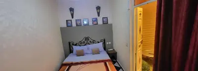 a small bedroom with a bed with a head board at Maison 211 in Marrakech