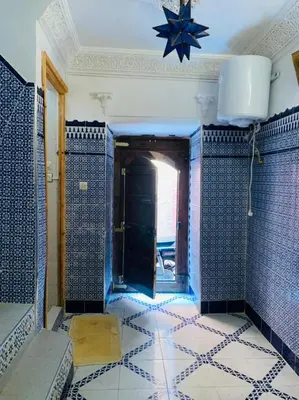 a bathroom with blue tiled walls and a star on the ceiling at Maison 211 in Marrakech