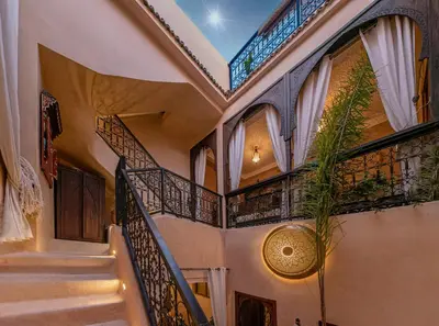 a staircase in a house with wrought iron railings at Riad Oumnia - Top emplacement - Riad en entier - Jacuzzi in Marrakech