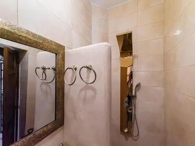 a bathroom with a mirror and a shower at Riad Oumnia - Top emplacement - Riad en entier - Jacuzzi in Marrakech