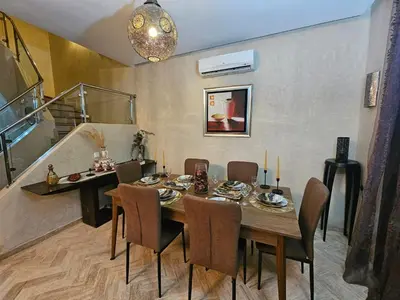 a dining room with a wooden table and chairs at atlas golf resort marrakech 