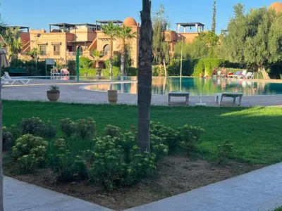 two benches in a park next to a pond at atlas golf resort marrakech 